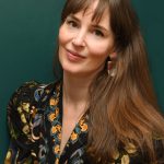 Author Annie Hartnett with dark floral shirt.